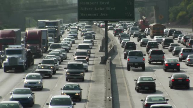 Traffic moves slowly along a busy freeway in Los Angeles.