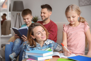 Fototapeta na wymiar Little children with parents doing homework at home