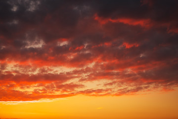 Fototapeta premium Fiery, orange and red colors sunset sky. Beautiful background