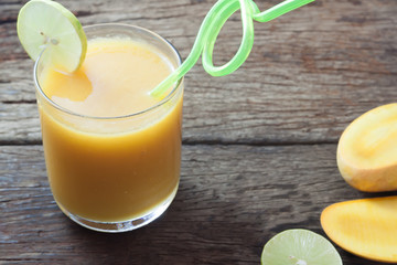 Summer drink, Tropical mango smoothie on wooden table, Summer holiday concept