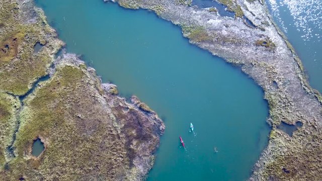 Aerial over kayakers rowing through vast bogs along the Nonesuch River near Portland, Maine, New England.