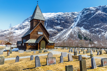 Roldal Stave Church (Roldal stavkyrkje) with snow cap mountain background - 196430755