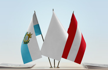 Flags of San Marino and Austria with a white flag in the middle