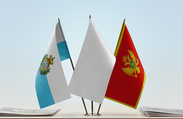 Flags of San Marino and Montenegro with a white flag in the middle
