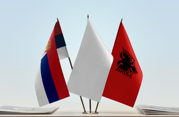 Flags of Serbia and Albania with a white flag in the middle