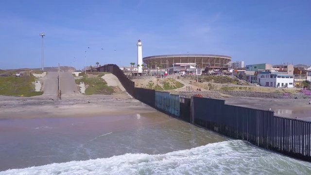 Good aerial of the U.S. Mexico border fence in the Pacific Ocean between San Diego and Tijuana.