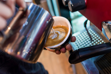 Coffee latte art in coffee shop by barista
