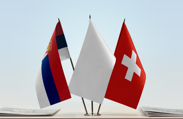 Flags of Serbia and Switzerland with a white flag in the middle