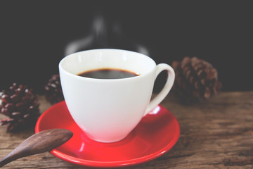 Close up hot coffee on rustic wooden table with retro filter, Vintage lifestyle
