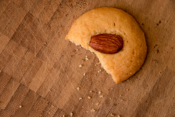 Simple butter cookies with almond on top on wooden tray. The closeup photo of homemade butter cookies.