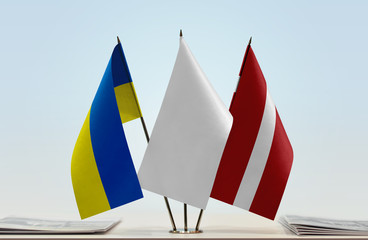 Flags of Ukraine and Latvia with a white flag in the middle