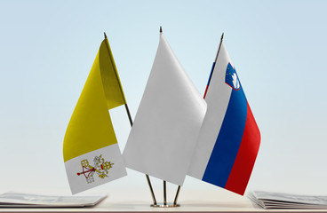 Flags of Vatican City and Slovenia with a white flag in the middle