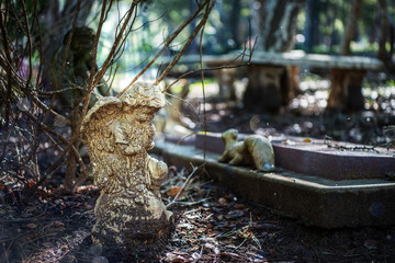 Winter scene in an old cemetary of a cherub lit with rays from the sun