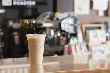 Ice coffee in take away cup.Indoor Cafe