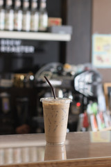 Ice coffee in take away cup.Indoor Cafe
