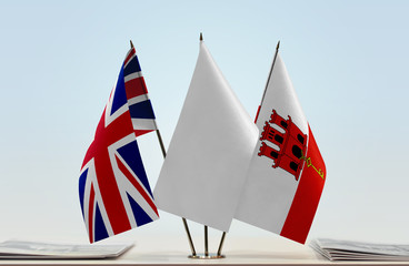 Flags of Great Britain and Gibraltar with a white flag in the middle