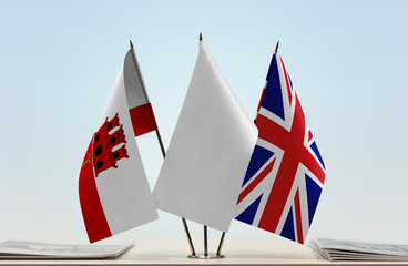 Flags of Gibraltar and Great Britain with a white flag in the middle