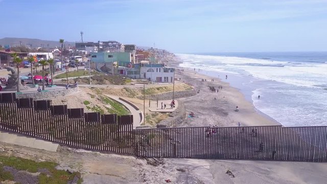 A dramatic aerial reveals the U.S. Mexico border fence in the Pacific Ocean between San Diego and Tijuana.