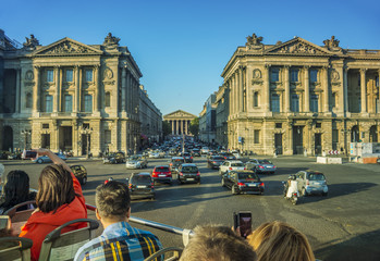Tourists taking photos from bus tour in Paris. France