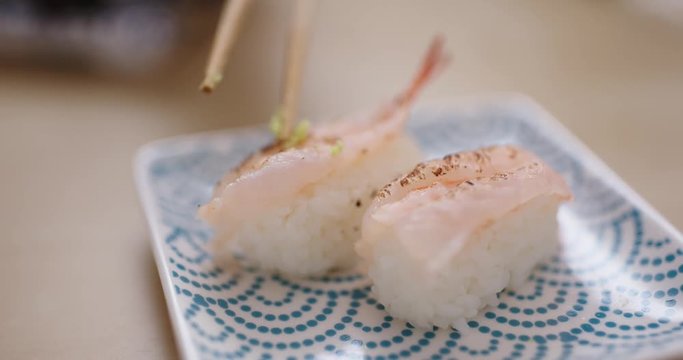 Having grilled shrimp sushi