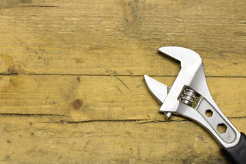 Adjustable wrench on a wooden workbench