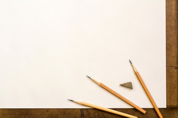 The background for a drawing. Paper, pencils.