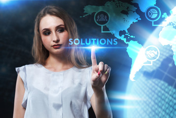 The concept of business, technology, the Internet and the network. A young entrepreneur working on a virtual screen of the future and sees the inscription: Solutions