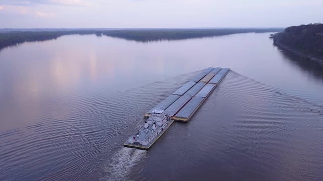 A beautiful aerial of a barge traveling on the Mississippi River.