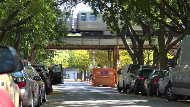 Establishing shot of a neighborhood in downtown Chicago wil El train passing.
