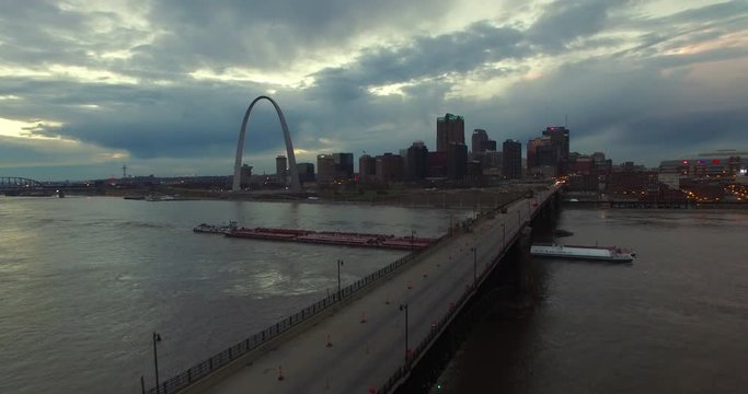 Beautiful aerial over a Mississippi river barge and bridge with the St. Louis, Missouri skyline background.