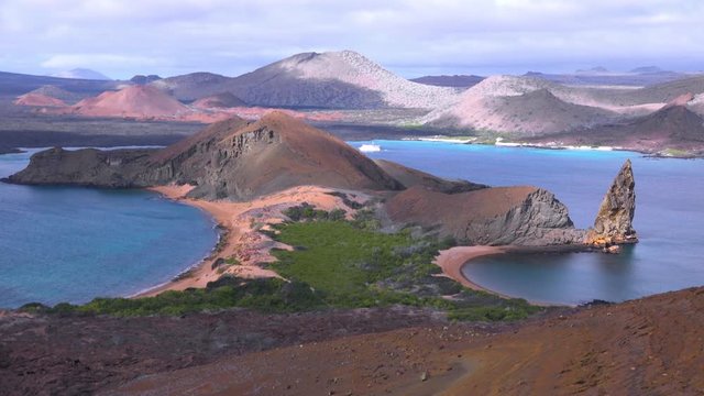 Establishing shot of the Galapagos Islands in Ecuador, with Pinnacle Rock in distance.