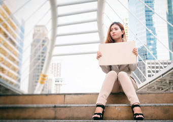 Unemployment. Young businesswoman with sign looking for a job.