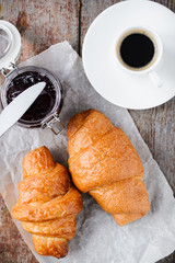 Breakfast of coffee and croissants with jam