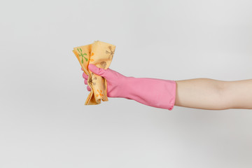 Close up of female hand in pink gloves holds and squeezes patterned orange rag for cleaning and...