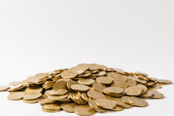 Close up of big pile of golden coins isolated on white background. Concept of money business growth gain success earnings. Copy space for advertisement. With place for text.