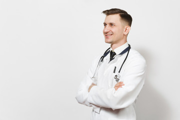 Fototapeta premium Smiling happy confident experienced handsome young doctor man isolated on white background. Male doctor in medical uniform, stethoscope looking aside. Healthcare personnel, health, medicine concept.