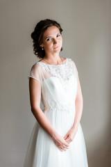 Portrait of young bride in a traditional white wedding dress