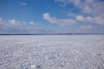 Fototapeta na wymiar snow covered beach and sea