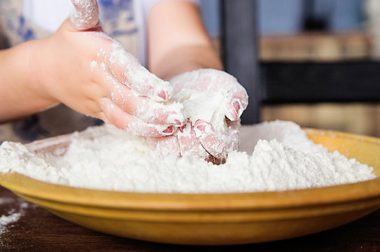 Children's Hands In A Bowl Of Flour