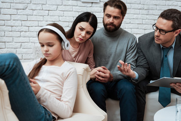 Young family at psychologist office with difficulties in raising daughter.