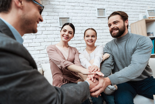 Adult man shakes hands with family psychologist who helped solve problem.