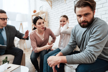 Young mother argues with husband when daughter is crying at psychologist's office.