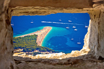 Zlatni rat beach aerial view through stone window