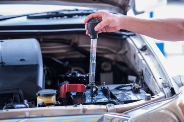 Using the battery hydrometer measuring gravity of battery distilled water, maintenance cars battery...