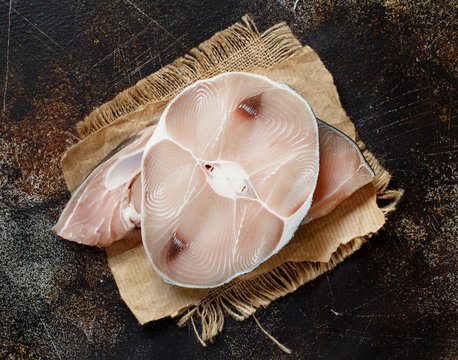 Two shark steak on a dark board