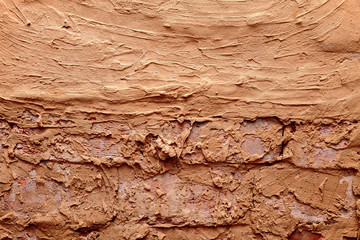 brick wall background anointed with clay
