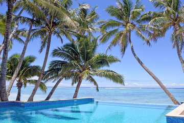 Fototapeta na wymiar Swimming pool in a tropical resort on a bright clear day