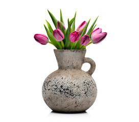 Lilac tulips in a concrete vase on a white background