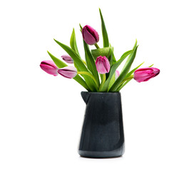Fototapeta na wymiar Lilac tulips in a blue vase on a white background
