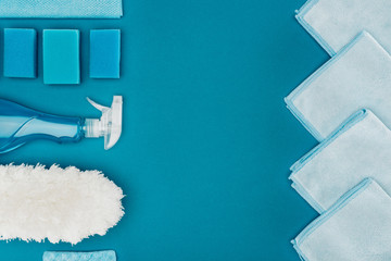 top view of row of blue rags and cleaning supplies isolated on blue